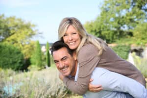 Couple in late 40s enjoying time in nature without needing to wear glasses. They are in love